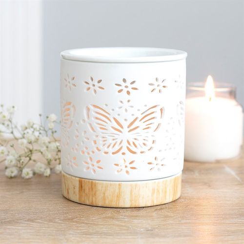 Pretty white ceramic oil burner and wax warmer with a matte finish with cut-out butterfly detail so that when a tealight is lit and placed within it lights up the pattern.