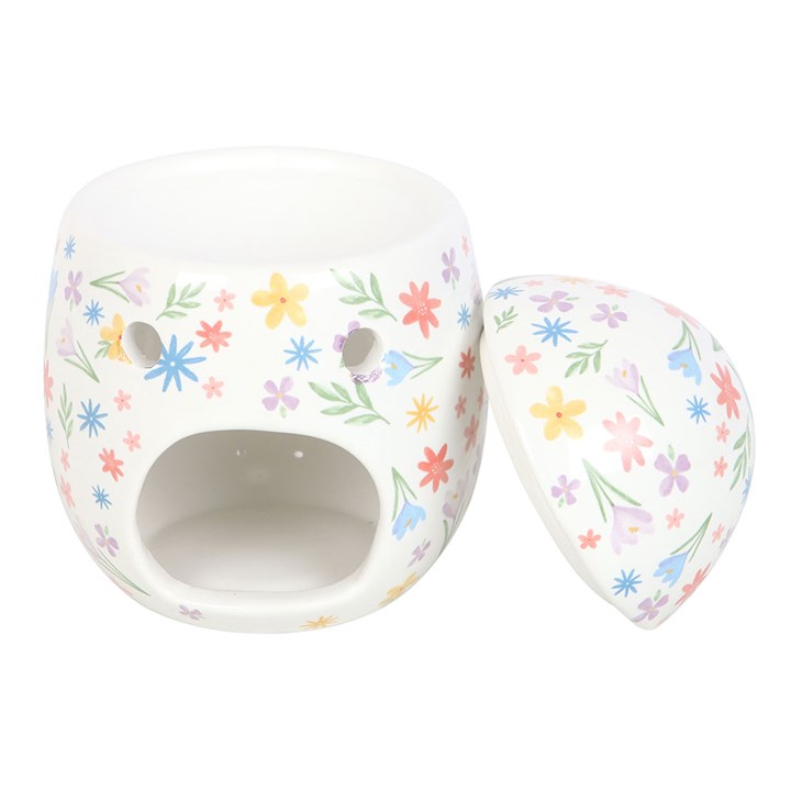 Stunningly detailed floral design adorned on a beatutifully designed egg shaped oil burner and wax warmer. This image depicts the removable top and cut-out for the tealight to warm your favourite fragrance oils or wax melts. Specially selected for its style and design by The Original Candle Company.
