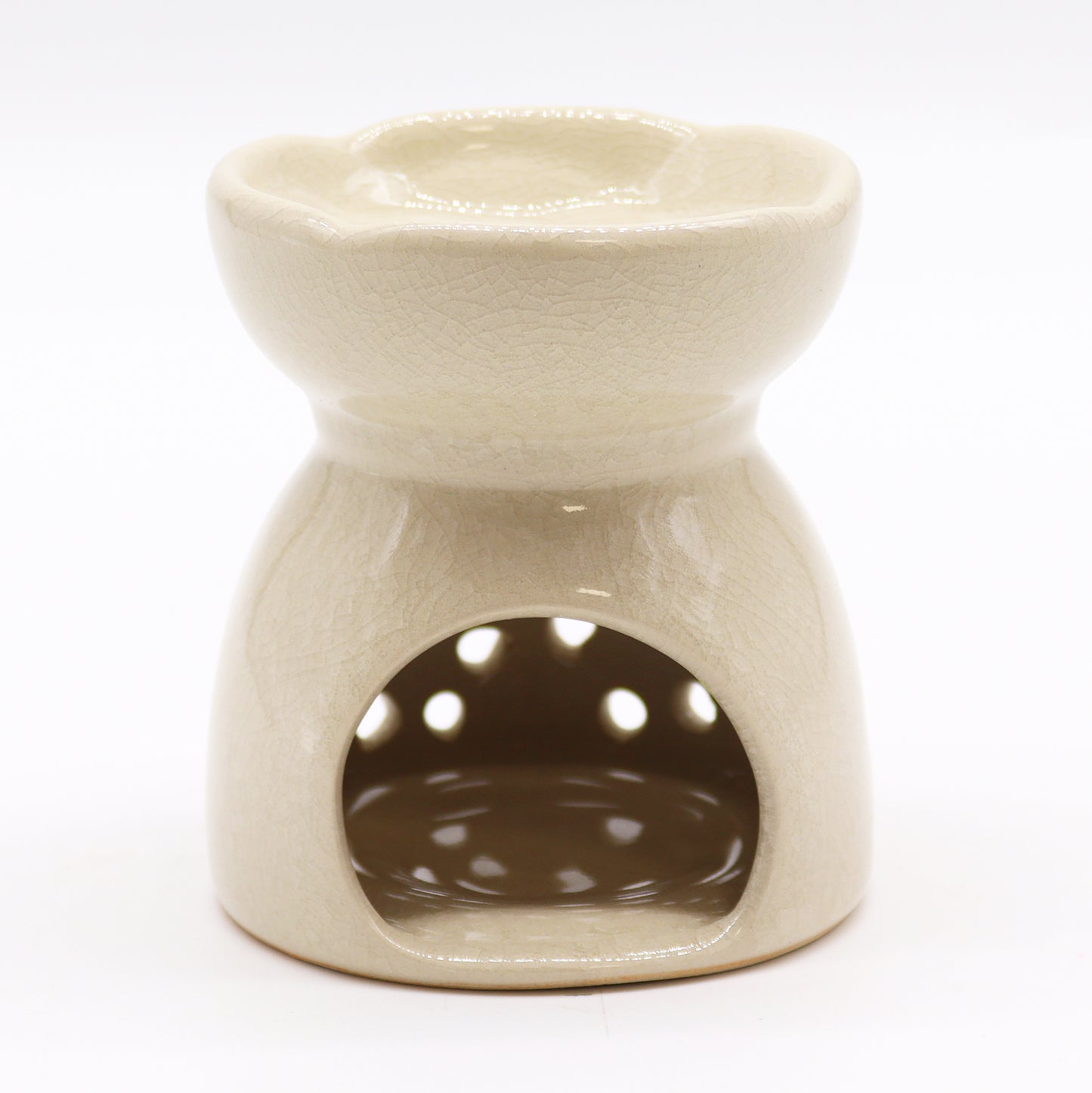Featuring a classic tree of life design with a highly decorative glaze in ivory, this oil burner and wax warmer will make an attractive decoration in any room. This image shows the cut-out where the tealight will sit.