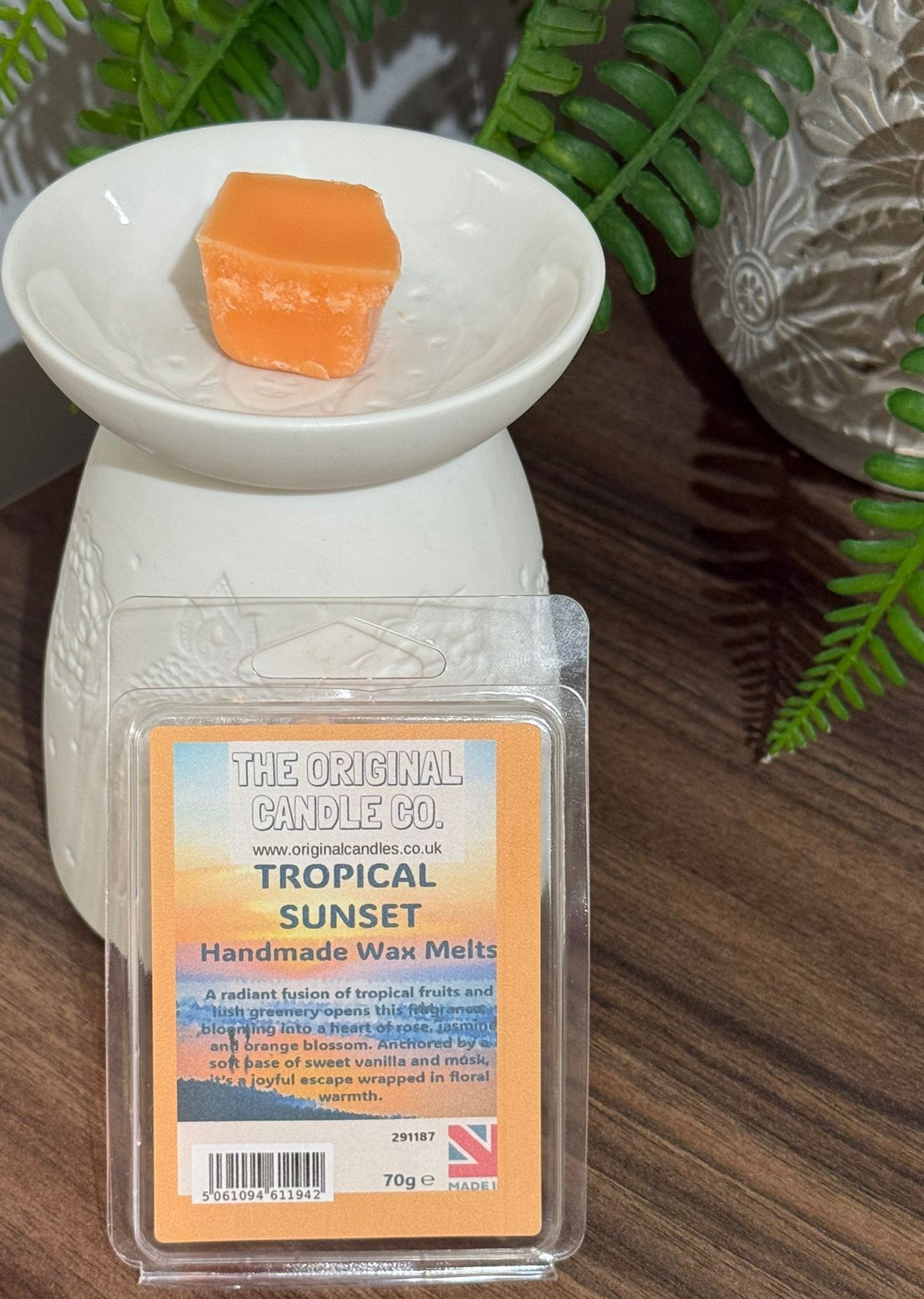 Tropical Sunset wax melt packaging with a wax melt in a white dish on a wooden surface.