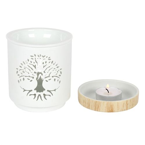 This white ceramic oil burner features a cutout Tree of Life design with a wood-effect ceramic base. Place fragrance oil or wax melts into the built-in dish with a standard tealight inside to fill the home with calming fragrance. Image shows the base where the tealight sits.