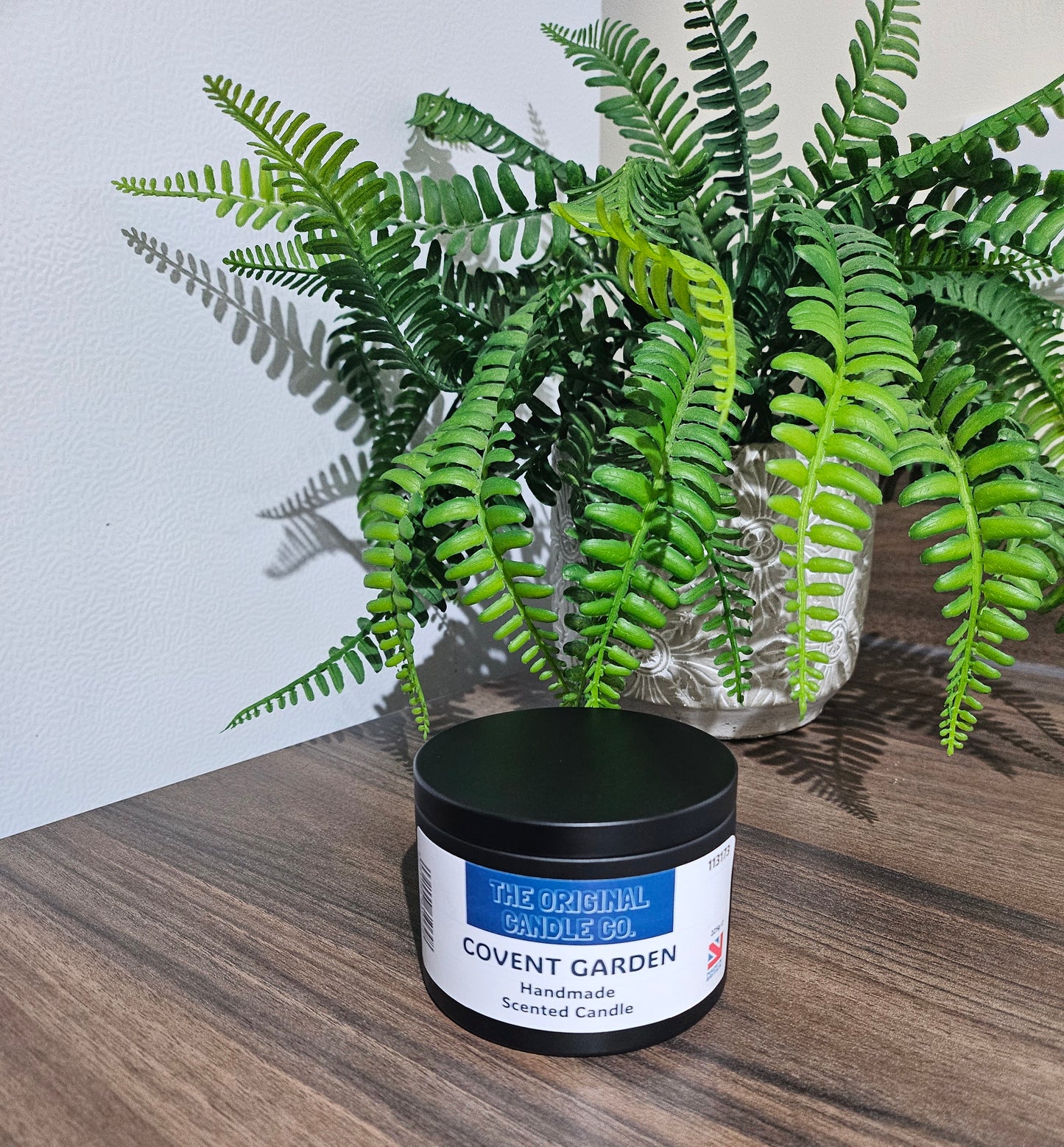 Covent Garden scented candle infused with vibrant citrus, delicate florals, and soft musk, creating an elegant and refined fragrance experience.