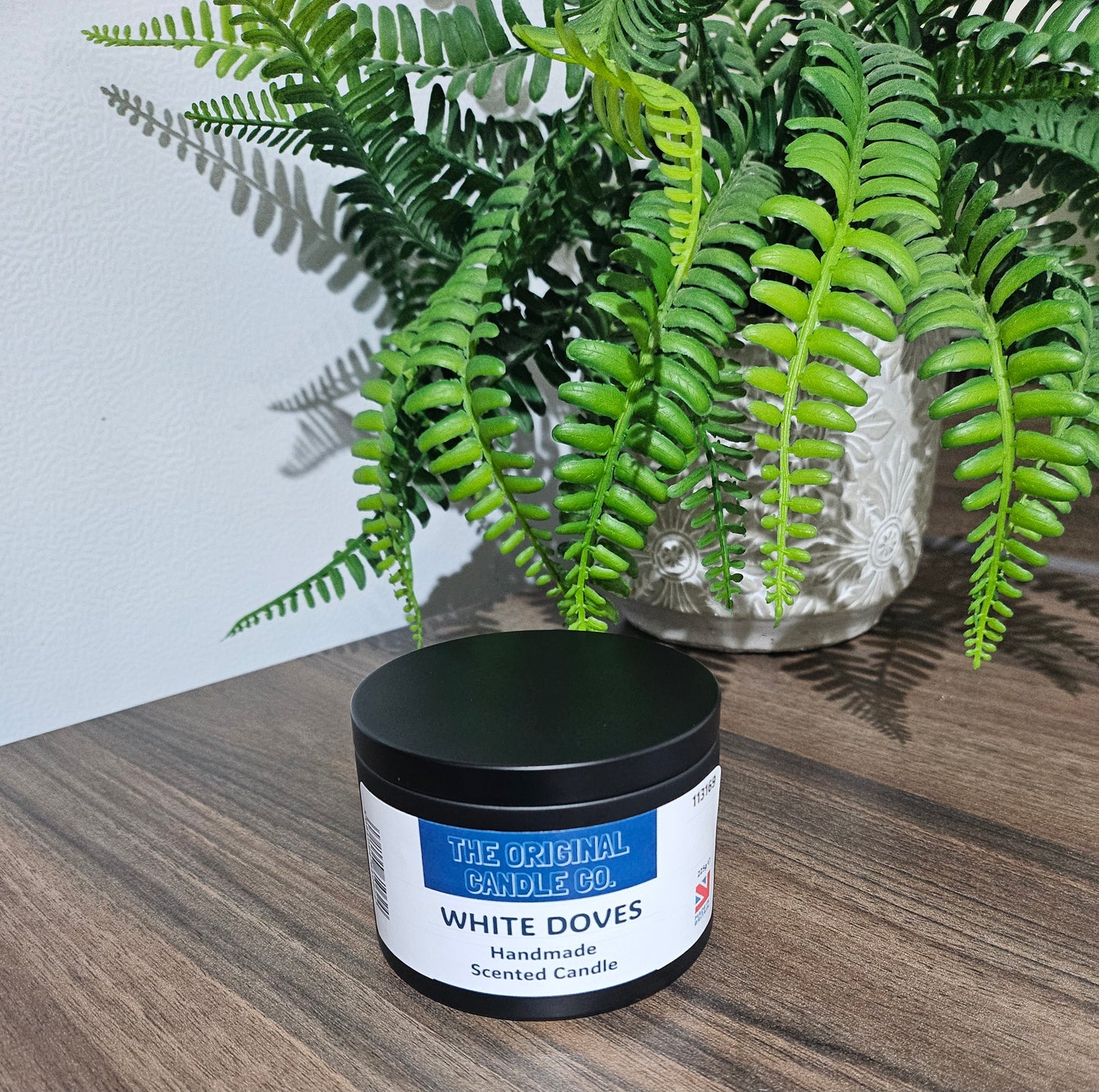 White Doves fragrance candle featuring delicate jasmine, earthy moss, and subtle buttermilk, delivering a warm and refined scent for any space.