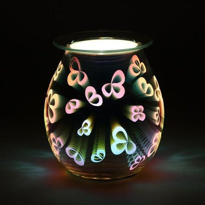 Carefully sourced and selected by The Original Candle Company, this electric oil burner and wax warmer is shown glowing, highlighting its intricate 3D flower petal design and creating a serene ambiance while diffusing fragrance effortlessly.