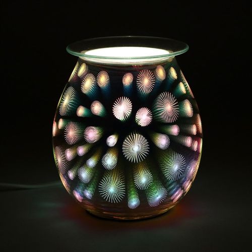 Carefully sourced and selected by The Original Candle Company, this electric oil burner and wax warmer is displayed glowing, showcasing its dazzling 3D starburst design while effortlessly diffusing fragrance for an inviting ambiance.