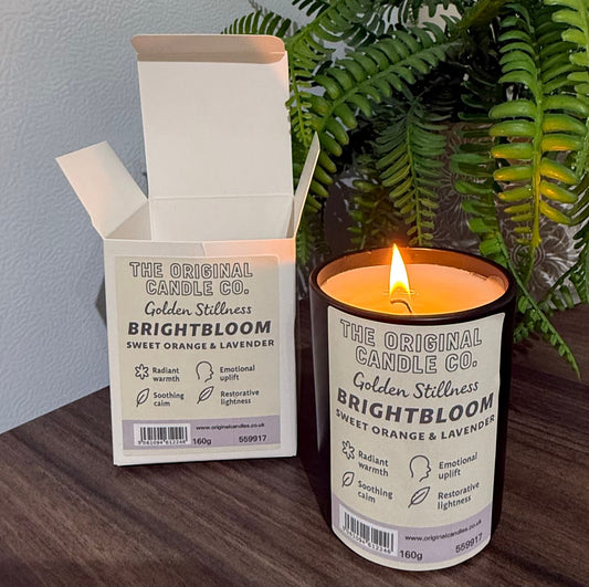 ADHD Autism Sensory candle from The Original Candle Co. with packaging on a wooden surface with a plant in the background