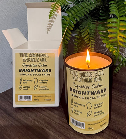ADHD Autism Sensory candle from The Original Candle Co. with packaging on a wooden surface with a plant in the background