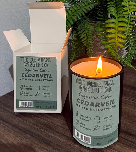 ADHD Autism Sensory candle from The Original Candle Co. with packaging on a wooden surface with a plant in the background