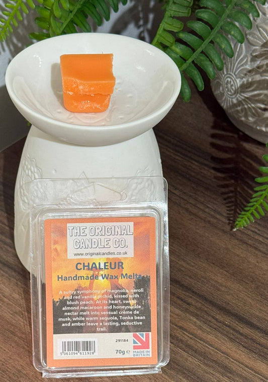 Handmade wax melt container with orange wax on a wooden surface The Original Candle Company