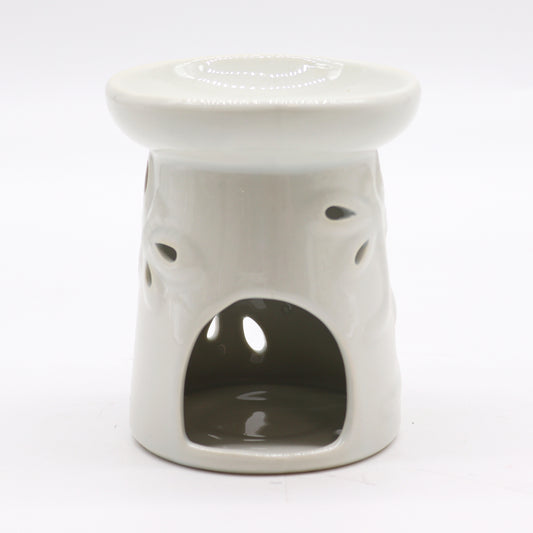 Carefully sourced by The Original Candle Company, this elegant white oil burner features a delicate dragonfly cut-out design. The image showcases its tealight cut-out for easy placement, blending beauty with practical functionality for a cosy home ambience.