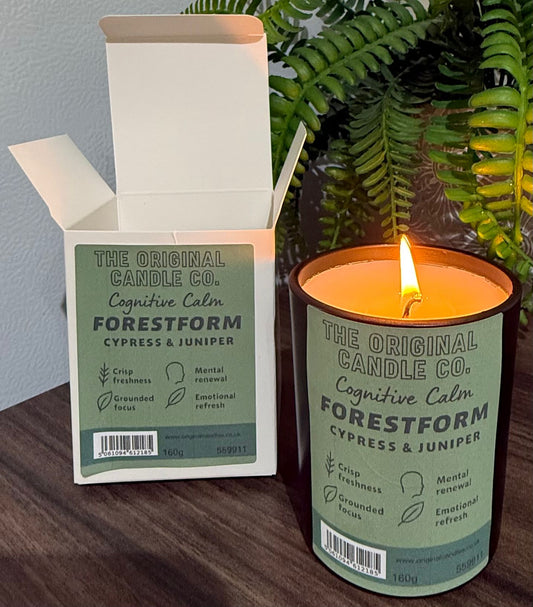 ADHD Autism Sensory candle from The Original Candle Co. with packaging on a wooden surface with a plant in the background