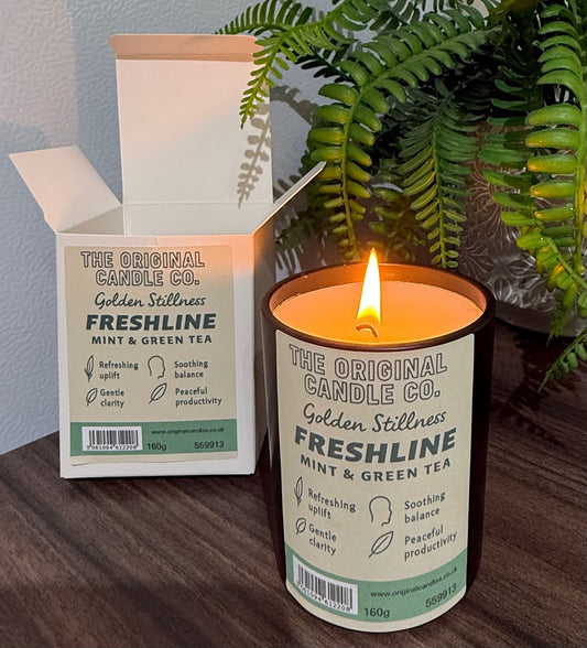 ADHD Autism Sensory candle from The Original Candle Co. with packaging on a wooden surface with a plant in the background