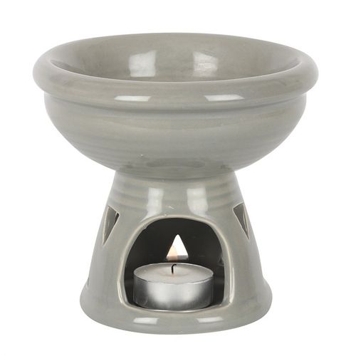 This large ceramic grey oil burner and wax warmer features an extra deep bowl and triangle cut outs at the base. Use with oils or wax melts to gently fragrance the home while creating a calming ambience with its understated, grey hue. This image depicts where the tealight will in the base.