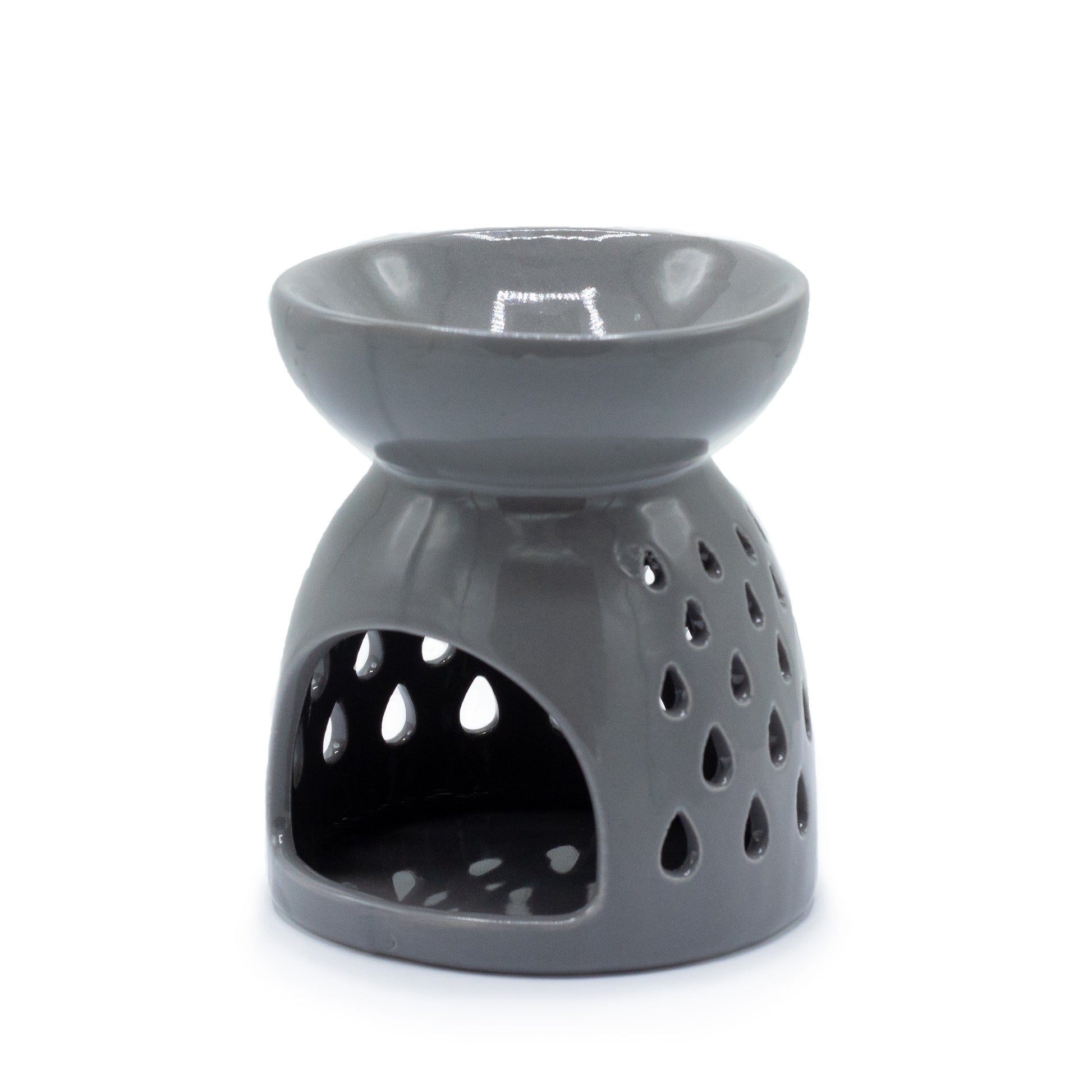 Carefully sourced by The Original Candle Company. A classic style oil burner and wax warmer featuring a teardrops cut-out design in a grey glaze, this oil burner and wax warmer will make an attractive decoration in any room. Showing the tealight cut0out opening.