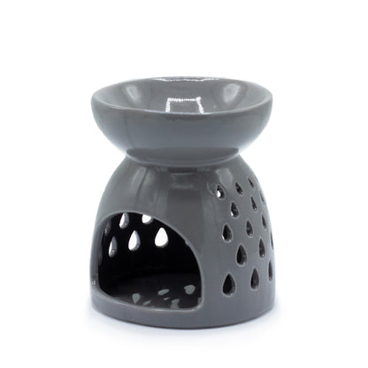 Carefully sourced by The Original Candle Company. A classic style oil burner and wax warmer featuring a teardrops cut-out design in a grey glaze, this oil burner and wax warmer will make an attractive decoration in any room. Showing the tealight cut0out opening.
