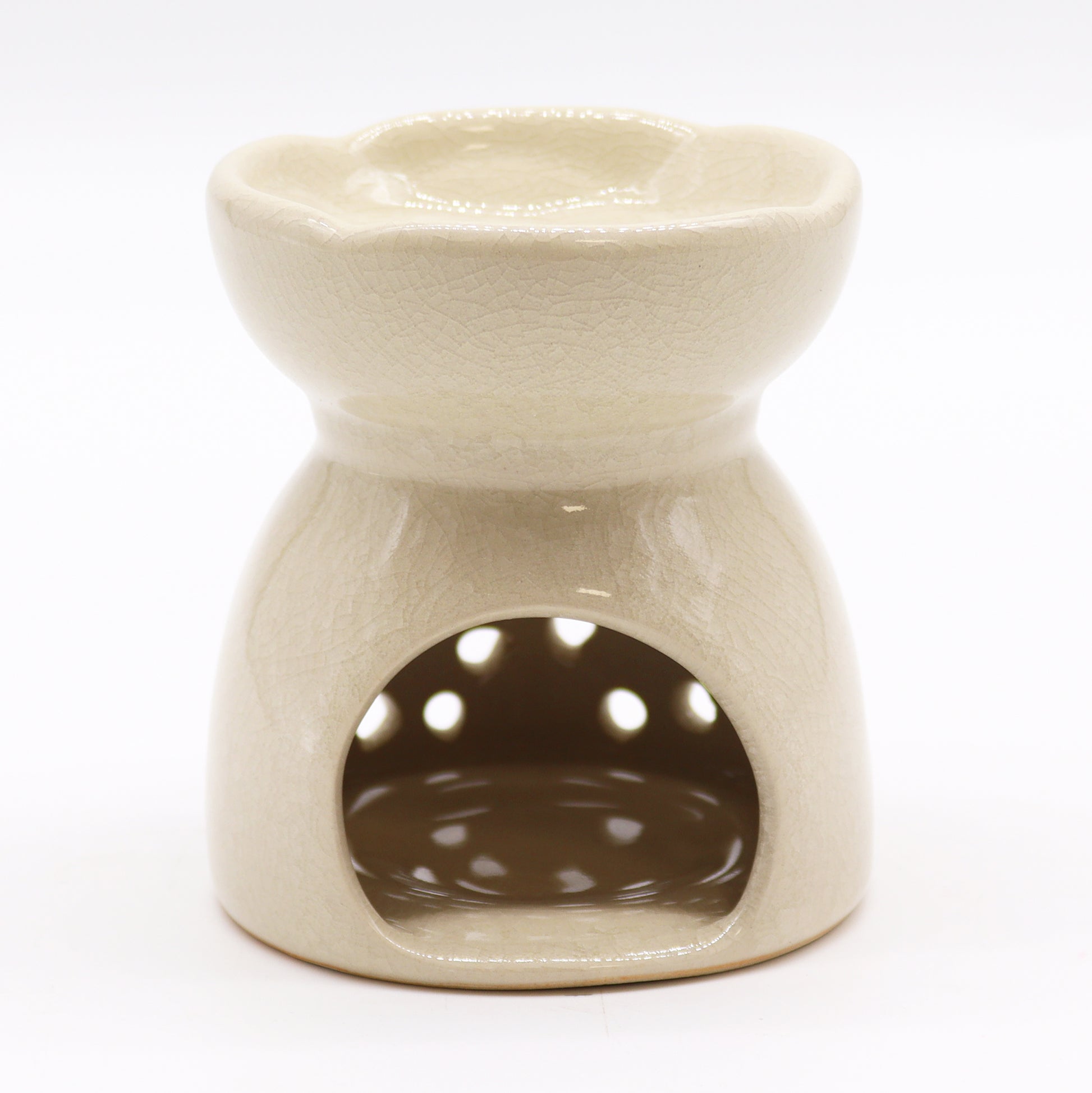 Featuring a classic tree of life design with a highly decorative glaze in ivory, this oil burner and wax warmer will make an attractive decoration in any room. This image shows the cut-out where the tealight will sit.