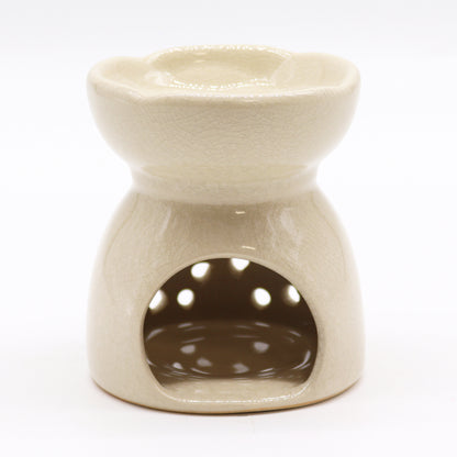 Featuring a classic tree of life design with a highly decorative glaze in ivory, this oil burner and wax warmer will make an attractive decoration in any room. This image shows the cut-out where the tealight will sit.