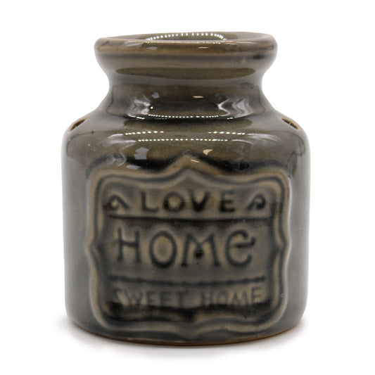 Carefully sourced by The Original Candle Company, this elegant large green oil burner features a 'Home Sweet Home' embossed design, bringing warmth and charm to any space. Perfect for diffusing essential oils or melting wax, it creates a cosy and inviting atmosphere with a touch of timeless elegance.