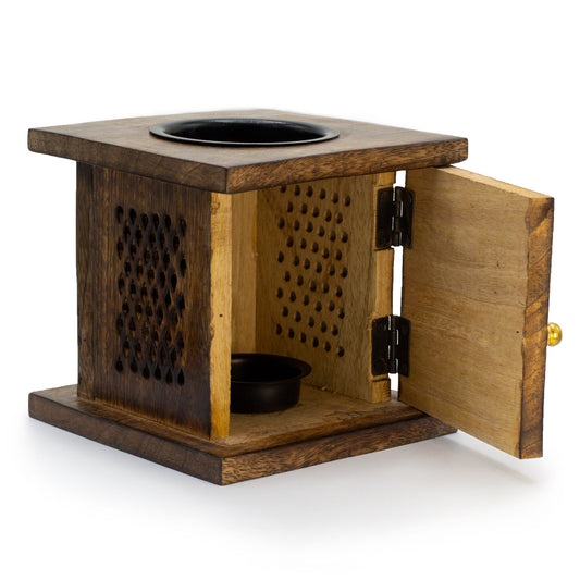 Designed for easy access, the open door view reveals the spacious compartment, perfect for holding a tealight candle. This feature enhances convenience while maintaining the burner’s timeless aesthetic, allowing soft, flickering light to dance through the carved Elephant design.
