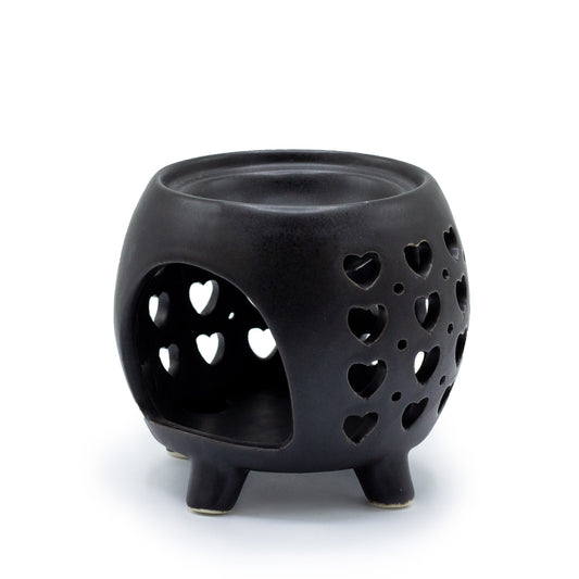 Carefullly sourced by The Original Candle Company and featuring a squat pot style with multi heart cut-out pattern in matt black, this oil burner and wax warmer will make an attractive decoration in any room. This image shows the rear of the oil burner & wax warmer where the tealight goes.