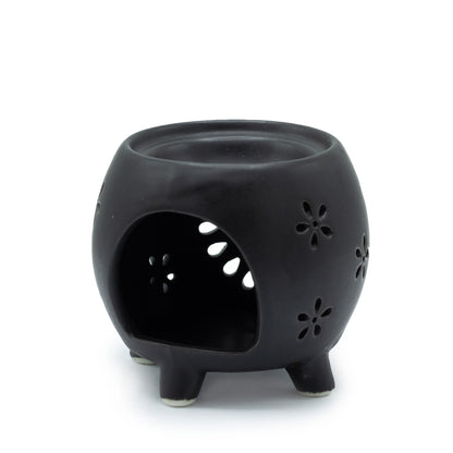 Carefully sourced by The Original Candle Company and featuring a squat pot style with flower purst pattern in matt black, this oil burner and wax warmer will make an attractive decoration in any room. This image shows the back with the cut-out for the tealight.