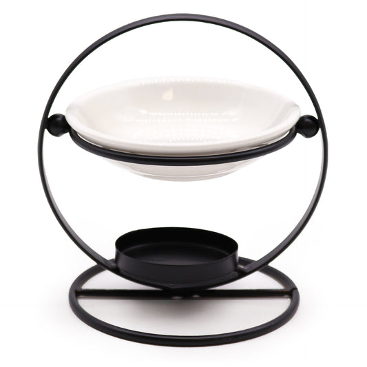 Carefully sourced by The Original Candle Company, this modern oil burner features a sleek black circular stand paired with a white removable ceramic warming dish. Designed for essential oils and wax melts, it offers a refined aesthetic with effortless functionality for luxury home ambiance