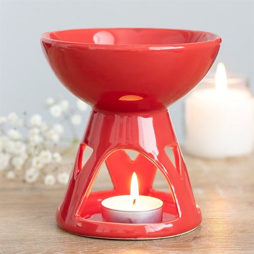 This beautiful red deep bowl oil burner and wax warmer has a simplistic and modern design featuring a large oil or wax well and triangle cut-out design. Image highlights the tealight cut-out