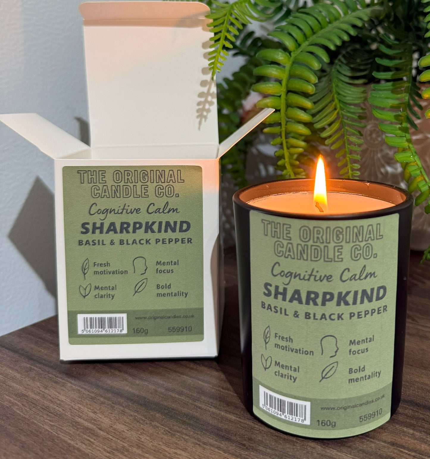 ADHD Autism Sensory candle from The Original Candle Co. with packaging on a wooden surface with a plant in the background