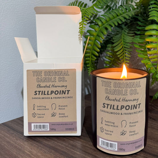 ADHD Autism Sensory candle from The Original Candle Co. with packaging on a wooden surface with a plant in the background