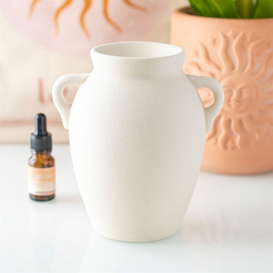 Carefully selected by The Original Candle Company. This elegant urn-style oil burner and wax warmer features a beautifully textured finish that will add a touch of sophistication to the home. Perfect for warming your favorite oils or wax melts, this burner will turn any space into a relaxing retreat with its soft, flickering glow.