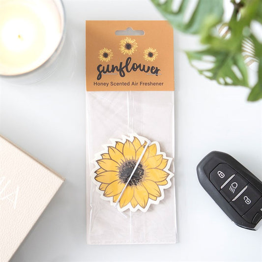 A fragranced sunflower design car air freshener in warm honey fragrance.