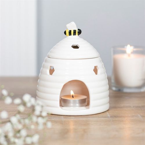 Carefully sourced by The Original Candle Company. This ceramic oil burner and wax warmer comes in the shape of an adorable white beehive with a sweet bee on the lid. Honeycomb-shaped cutouts finish off this unique style. Always remove the lid whilst in use.