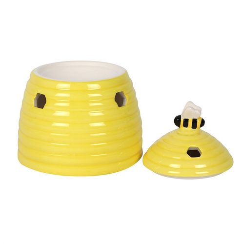 This ceramic oil burner comes in the shape of an adorable yellow beehive with a sweet bee on the lid. Honeycomb-shaped cutouts finish off this unique style.  Image shows the removable lid next to the burner.