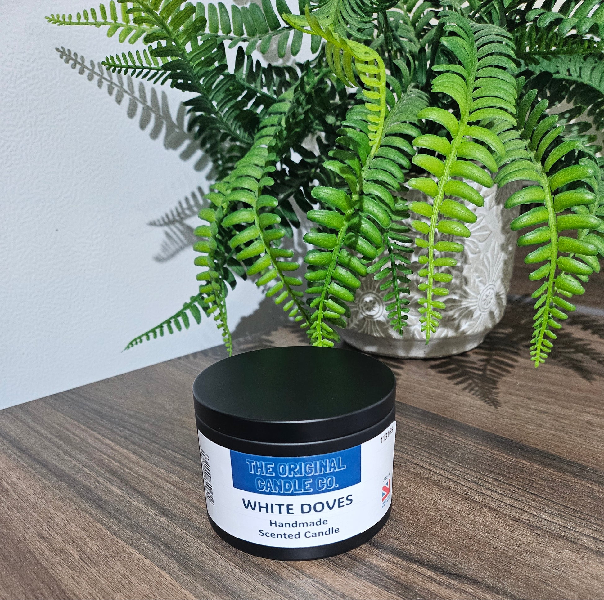 White Doves fragrance candle featuring delicate jasmine, earthy moss, and subtle buttermilk, delivering a warm and refined scent for any space.
